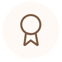 Minimalist brown ribbon badge icon on a pale background.